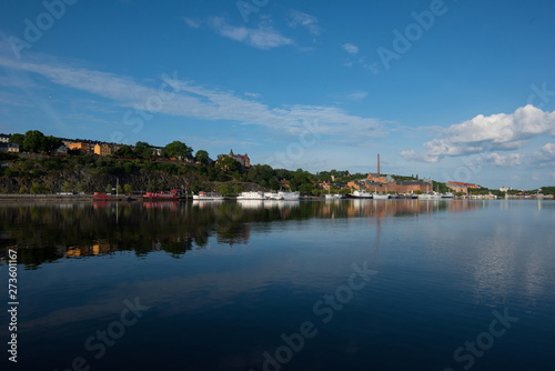 Boats, pier and landmarks in Stockholm a tranquil morning, 