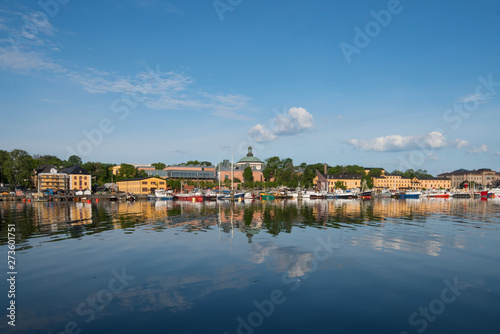 Boats, pier and landmarks in Stockholm a tranquil morning, 