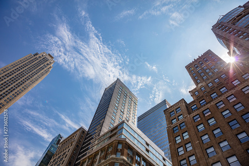 New York  Manhattan. High buildings view from below against blue sky background