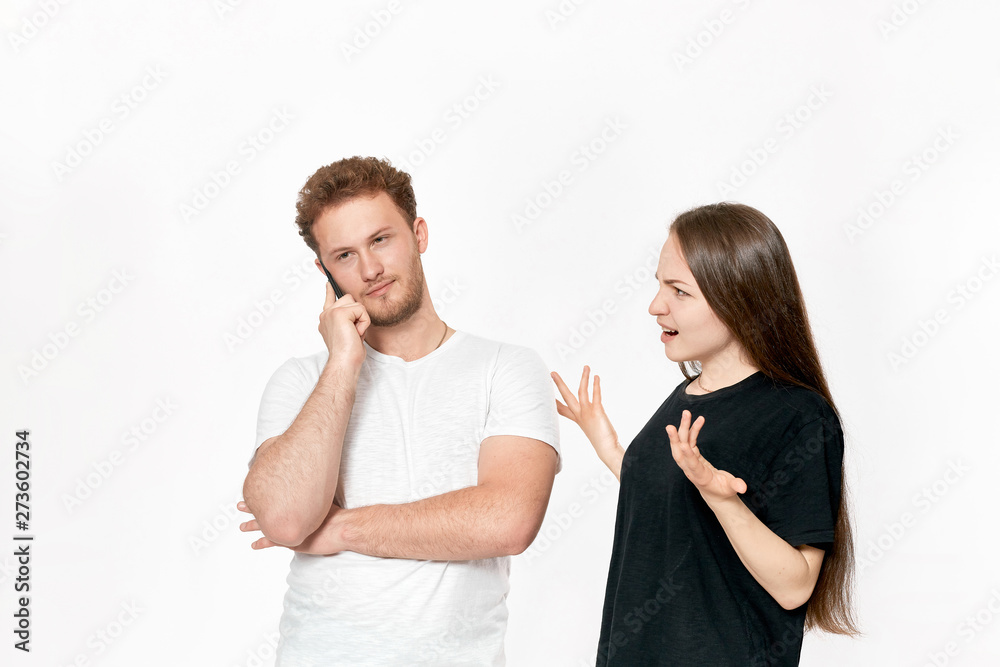 Studio shot of a couple quarreling. Angry woman shouting at the partner Studio shot of a couple quarreling. Angry woman shouting at the partner