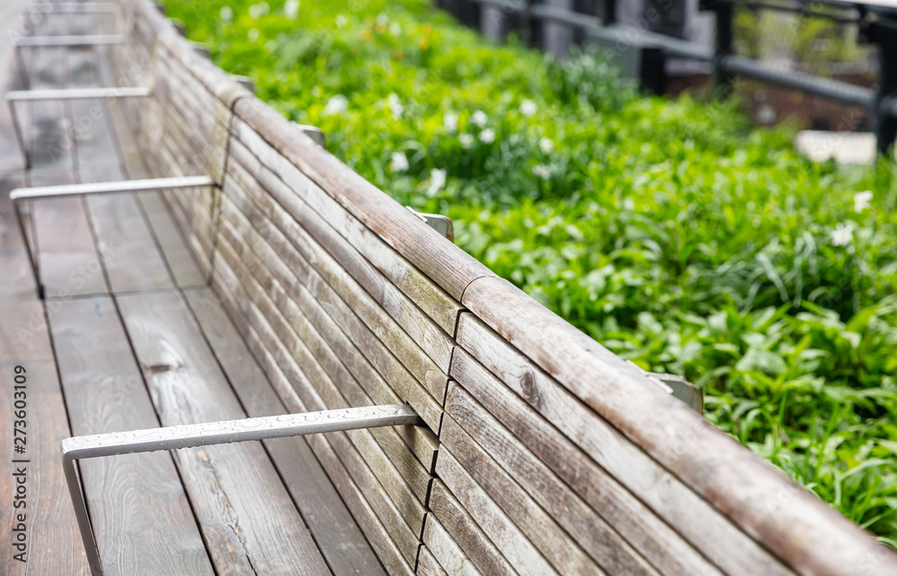 Wooden bench, empty after the rain, Manhattan New York Wooden bench, empty after the rain, Manhattan New York