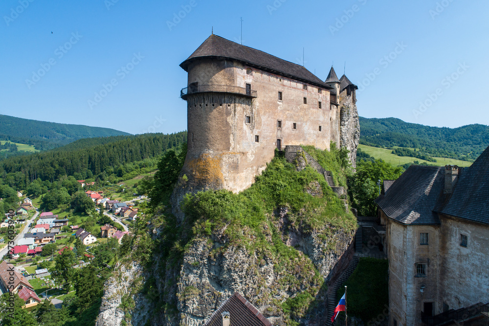Orava castle - Oravsky Hrad in Oravsky Podzamok in Slovakia. Medieval fortress on extremely high and steep cliff. Aerial view.