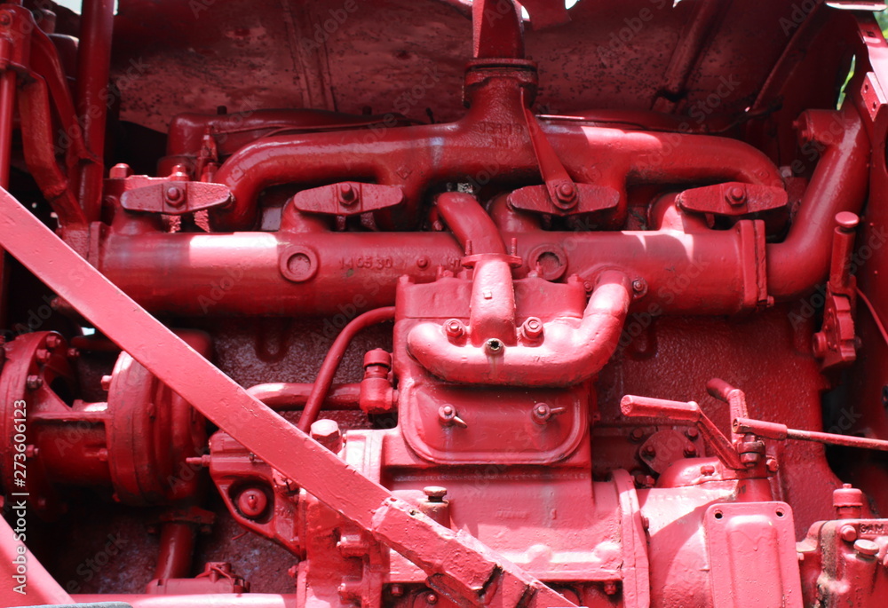 The engine of the old tractor is red. Part of the engine tracked vehicles. Big spring. The engine of the old tractor is red. Part of the engine tracked vehicles. Big spring.