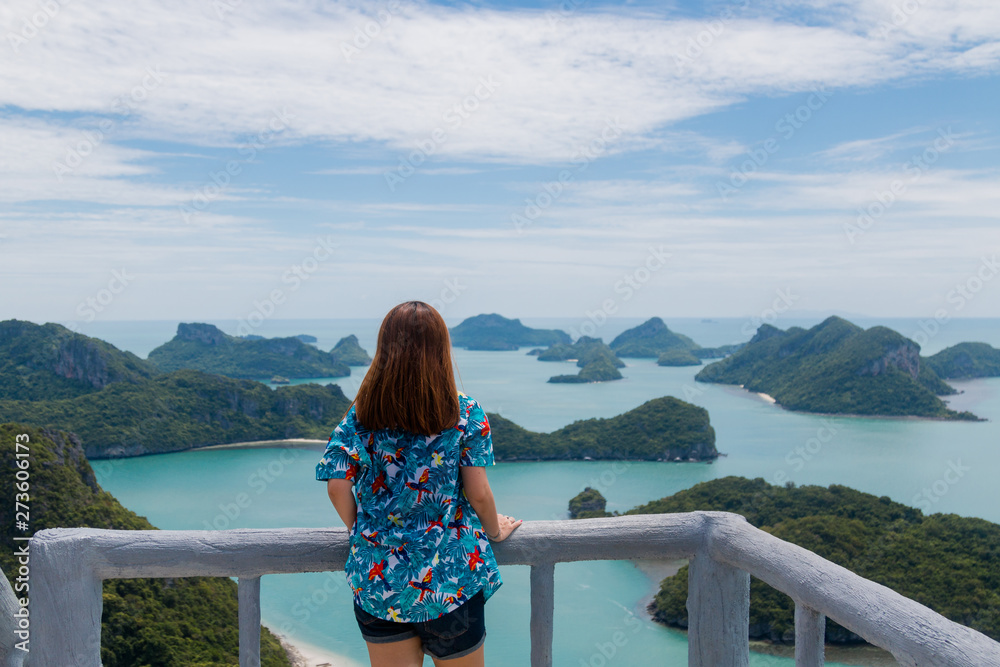 Young asian woman traveler with backpack looking view at view point at Moo Koh Angthong, Thailand.