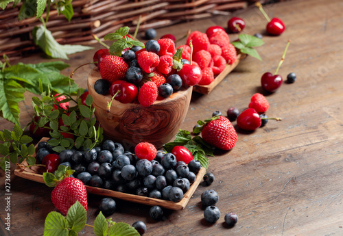 Canvas Print Berries closeup colorful assorted mix of strawberry, blueberry, raspberry and sweet cherry on a old wooden table