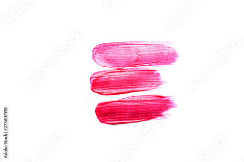 Smudged pink liquid lipstick, liquid blush isolated on white background. Concept of make up and beauty.