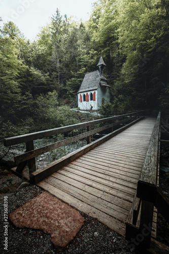 Beautiful scenery of a church in the national park st bartholomew with a bridge photo