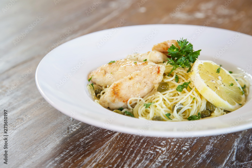 Battered salmon fish fillet dinner with noodles on a plate	
