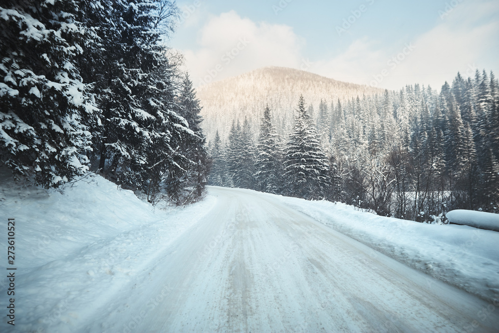 road in winter forest with mountain ahead road in winter forest with mountain ahead