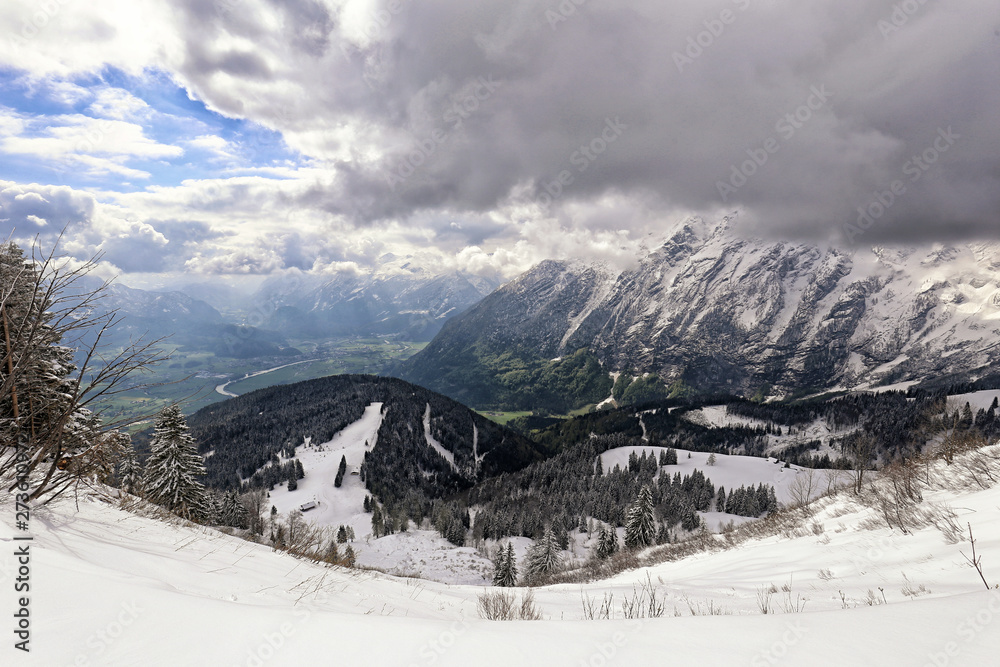 Deep Alpine valley by Salzburg city under high mountains