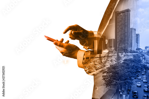 Double Exposure of Businessman hold Digital smart Tablet or Smartphone with Modern City Traffic scene