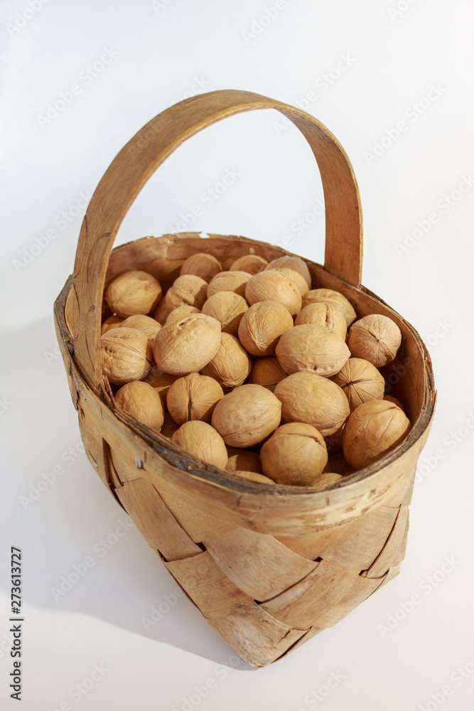 Walnuts in the basket on white background