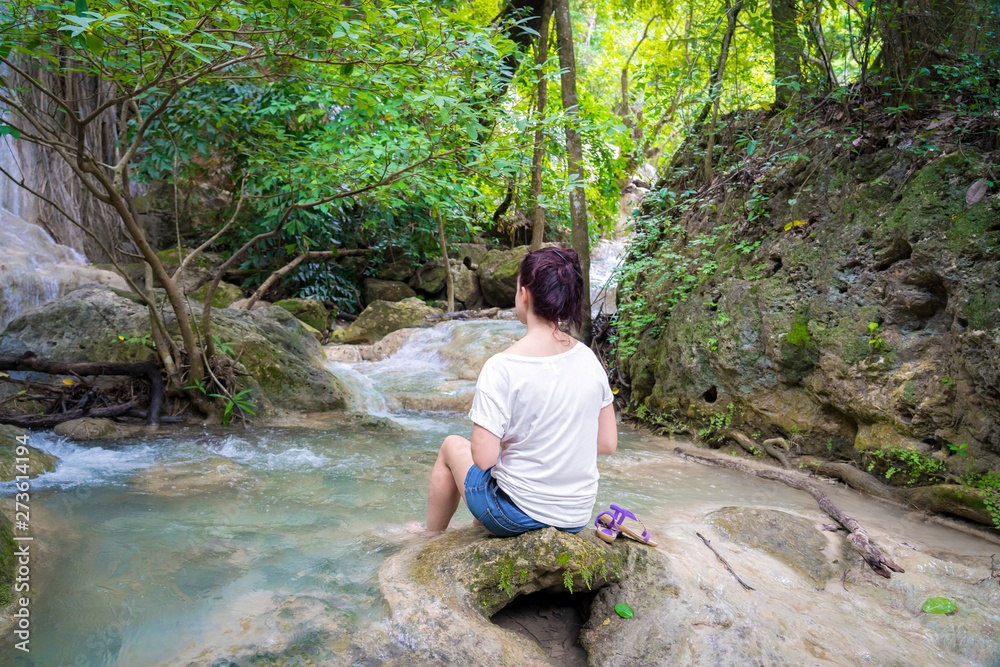 Young girl traveling at beautiful Erawan waterfall National Park Kanchanaburi, Thaialnd Young girl traveling at beautiful Erawan waterfall National Park Kanchanaburi, Thaialnd