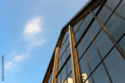 Modern industrial building with gable shape with glass reflection