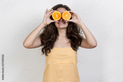 Brunette woman holding an orange