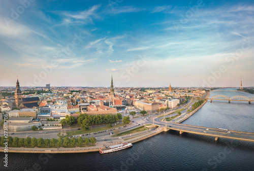 Panoramic view over Riga city at sunset. Iconic railroad bridge and old town panorama. Picturesque scenery of historical architecture. National library of Latvia.  © Viesturs