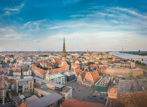 Panoramic view over Riga city at sunset. Iconic railroad bridge and old town panorama. Picturesque scenery of historical architecture. National library of Latvia. 