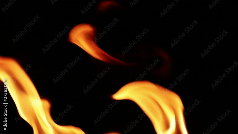 Close Up of flames burning on black background, slow motion. Close Up of flames burning on black background, slow motion.