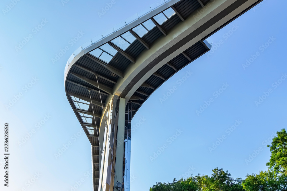 KIEV, UKRAINE - JUNE 15, 2019: and the new cycling pedestrian bridge opened, on May 25, 2019 , connecting the Arch of Friendship of Peoples with the Mount of St. Vladimir. The concept of tourism KIEV, UKRAINE - JUNE 15, 2019: and the new cycling pedestrian bridge opened, on May 25, 2019 , connecting the Arch of Friendship of Peoples with the Mount of St. Vladimir. The concept of tourism