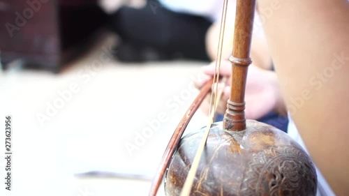 Asian playing thai violin or fiddle Thai traditional music instrument.