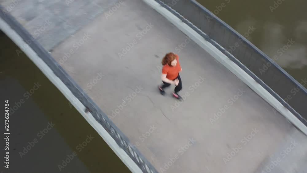 custom made wallpaper toronto digitalShooting from the air red-haired sports woman enthusiastically running along the embankment of the city river