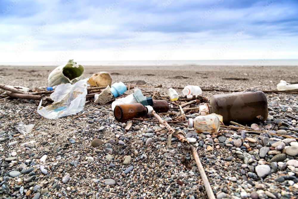 Plastic and medical waste materials at the beach. Singleuse plastic is