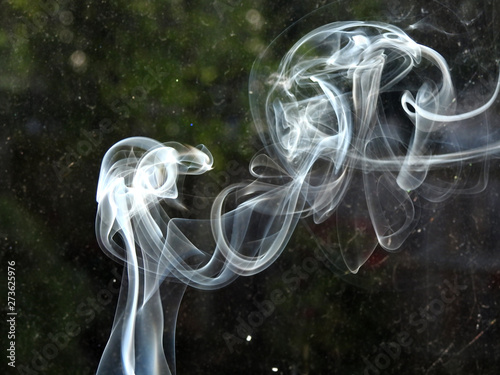 background abstract of white whisp of smoke from incence stick smoking kills air dust