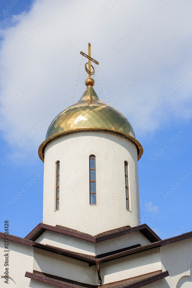 White Christian church on a background of clear blue sky. City architecture