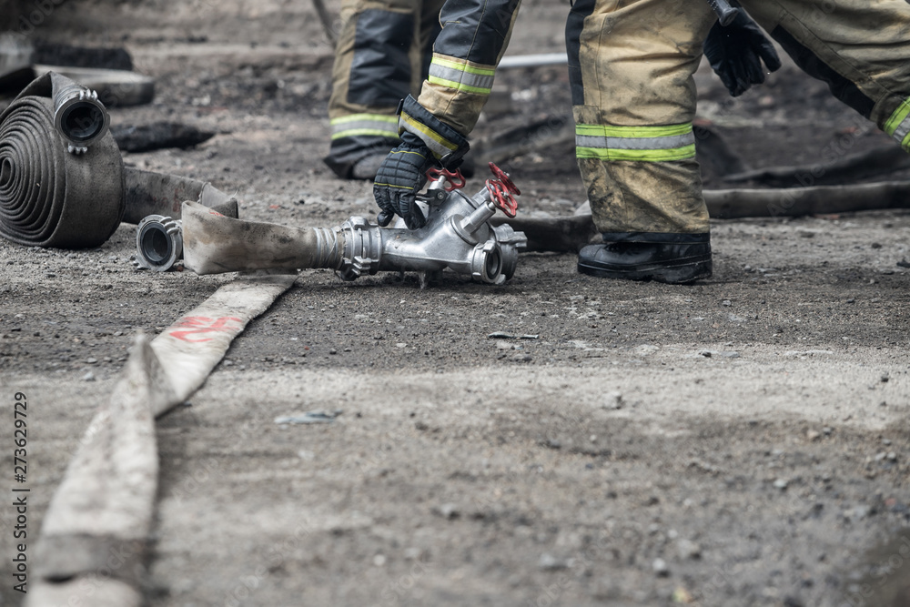 Firefighter rescue working from burning building in fire and smoke incident. Firefighter rescue working from burning building in fire and smoke incident.
