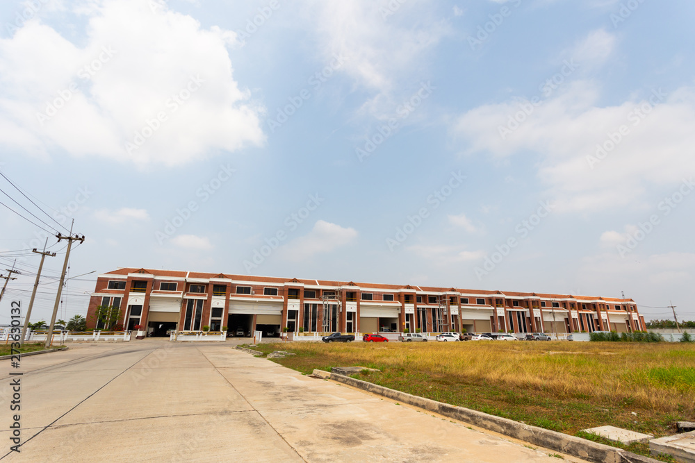 Blue sky and below is road and warehouse area among sun light