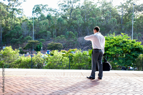 White shirt man holding a office bag