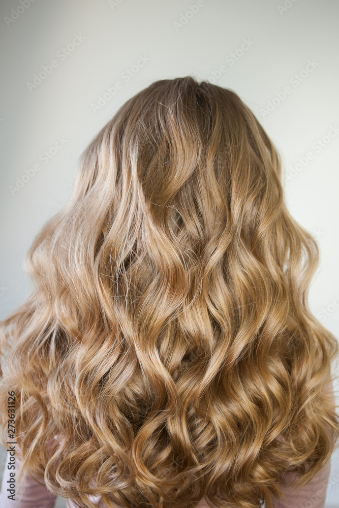 Naklejka premium blond with perfect curls, long hair with curls,