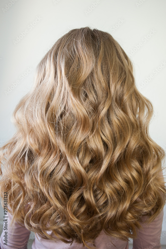 Naklejka premium blond with perfect curls, long hair with curls,
