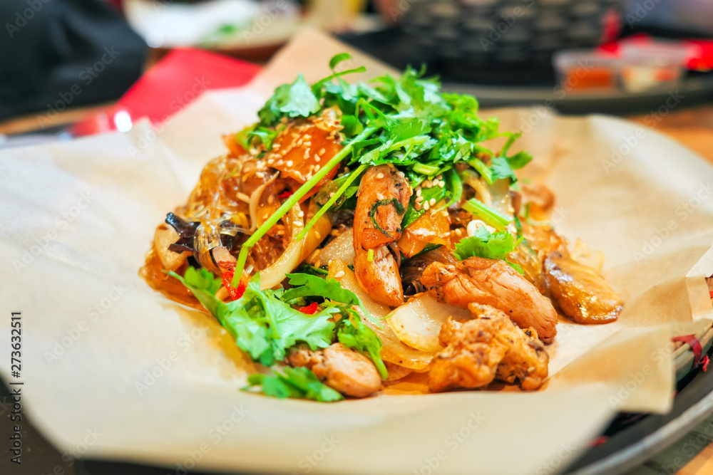 Wicker plate of traditional vietnamese dish - glass noodles with chicken meat and vegetables Wicker plate of traditional vietnamese dish - glass noodles with chicken meat and vegetables