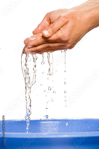 female hands with water flowing out of them on white background