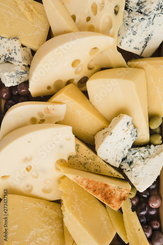 Collection of fresh cheese slices with olives
