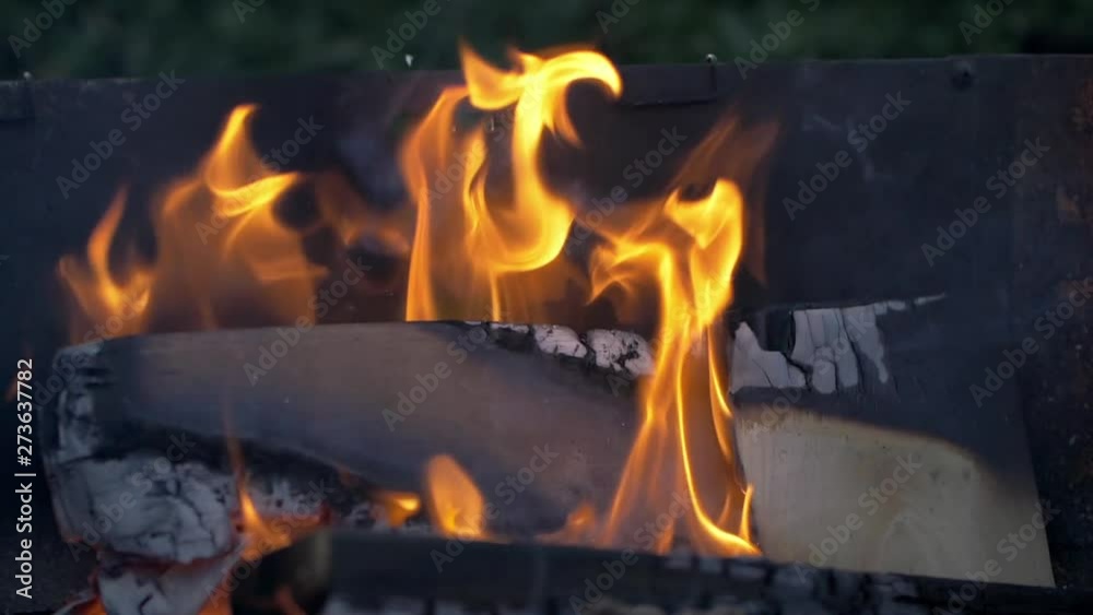 Burning Wood With Flames And Fire In Slow Motion, a stack of wood on a grill burns down in slow motion. filmed in 200fps. Burning Wood With Flames And Fire In Slow Motion, a stack of wood on a grill burns down in slow motion. filmed in 200fps.