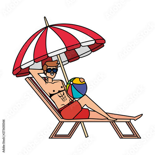 young man in beach chair with balloon toy and umbrella