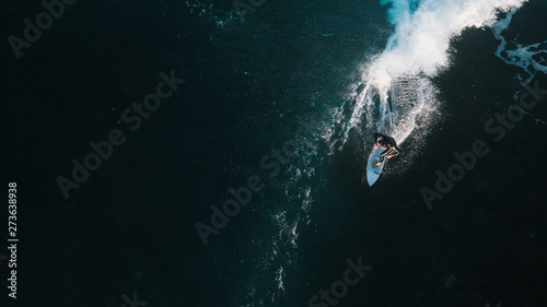 Aerial Perspective of Surfers on Wave at Sunrise at Bells Beach, Great Ocean Road, Australia