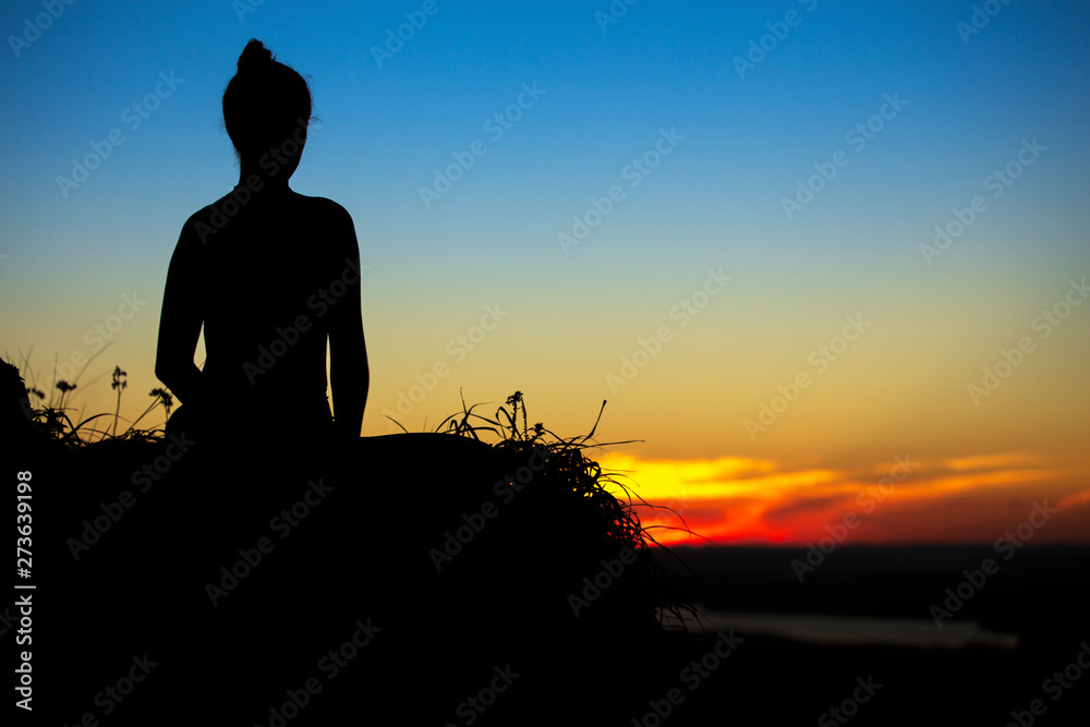 Woman meditation yoga at the mountain with sunset