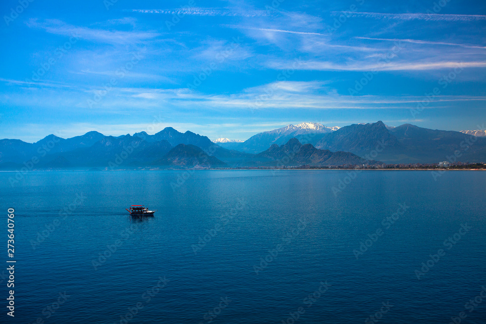 Beautiful landscape of mountains and ship in the Mediterranean sea in Turkey, Antalya.