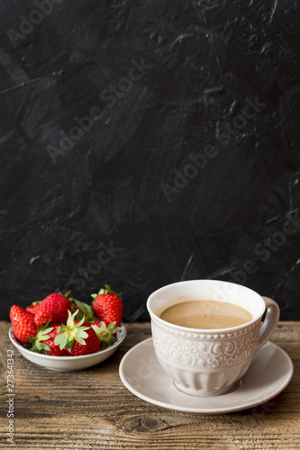 Coffee cup and strawberries