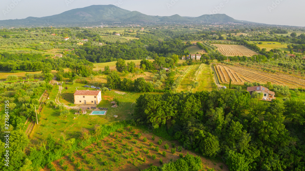 Aerial view on the Irpinia countryside in the province of Avellino, Italy. Among the cultivated fields and woods in the mountains there is some isolated house.