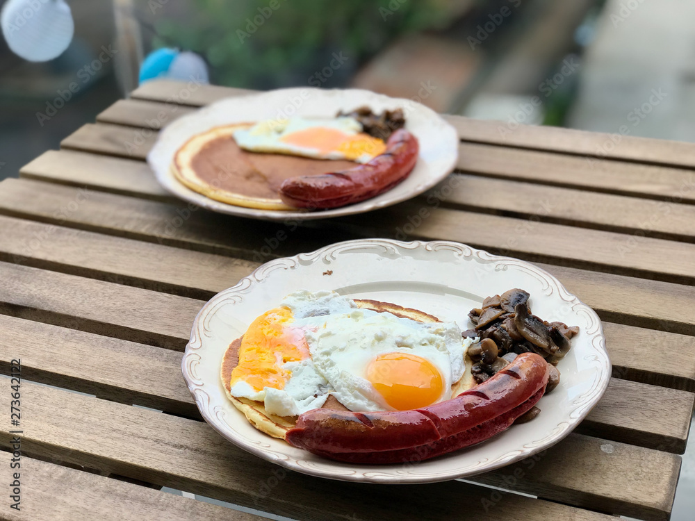Bratwurst Sausage German Breakfast with Pancake, Fried Eggs and Mushrooms. Bratwurst Sausage German Breakfast with Pancake, Fried Eggs and Mushrooms.