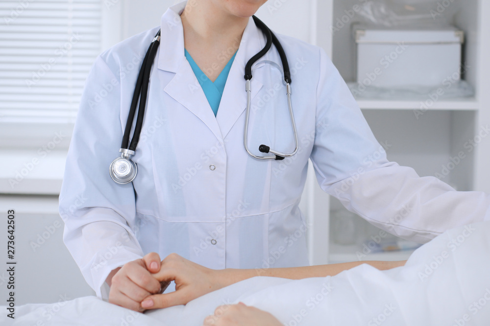 Female doctor reassuring her patient in hospital ward. Medicine and health care Female doctor reassuring her patient in hospital ward. Medicine and health care