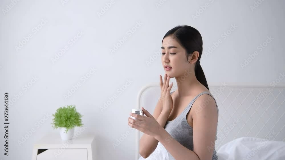 Beauty concept. Asian girls are applying skin cream in the room. Beauty concept. Asian girls are applying skin cream in the room.