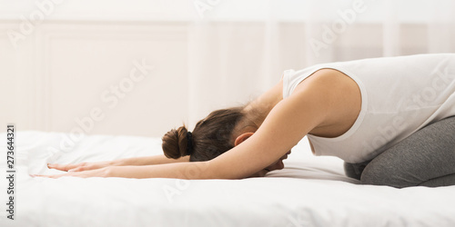 Photography Woman Practising Yoga In Child Pose On Bed