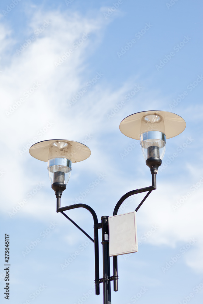 Lamppost on a cloudy sky background