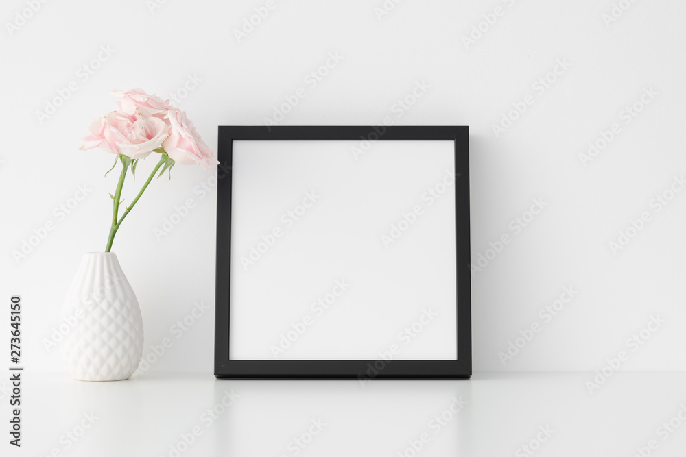 Black square frame mockup with soft pink roses in a vase. Black square frame mockup with soft pink roses in a vase.