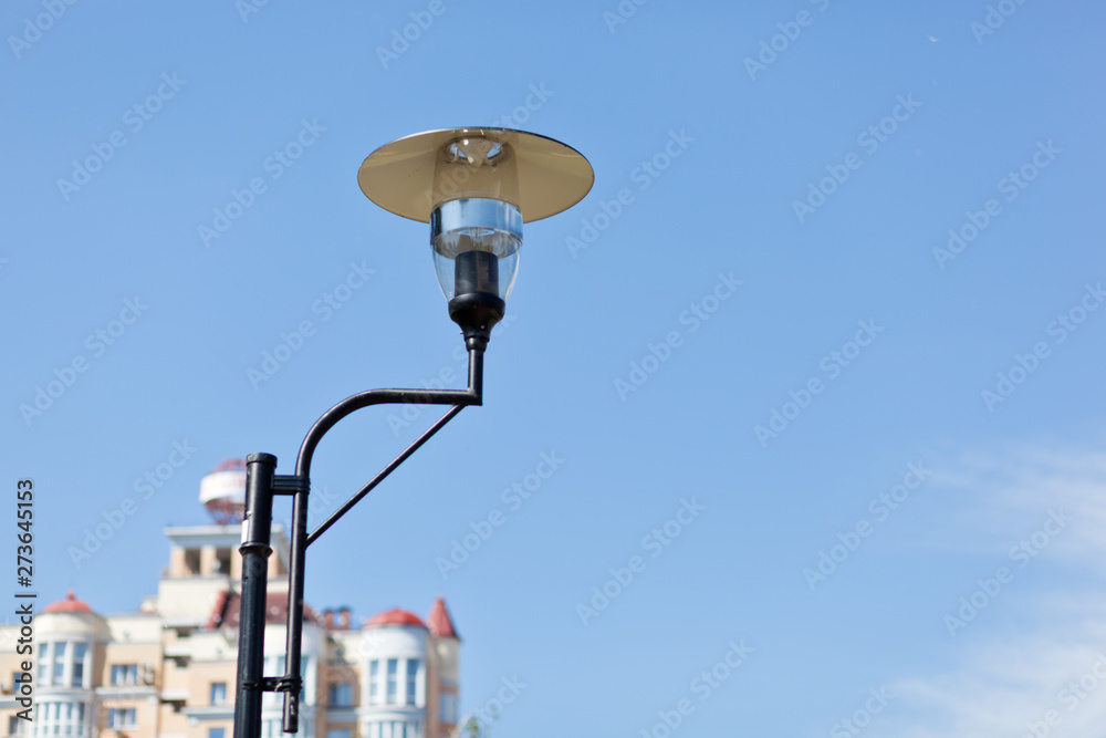 Lamppost on a cloudy sky background